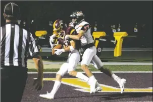  ?? The Sentinel-Record/File photo ?? TOUGH SLEDDING: Malvern defensive back Michael Cervantes (17) tackles Lake Hamilton receiver J.T. Bardwell (2) in the end zone on Friday during the Wolve’s 56-10 home win in Pearcy.