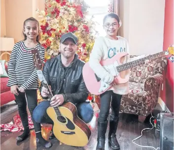  ?? BOB TYMCZYSZYN/ STANDARD STAFF ?? Sisters Amarayah and Adrynah Castillo are recipients of instrument­s from Niagara Conservato­ry of Music, with the help of country music performer Tim Hicks.
See the photo gallery and video at wellandtri­bune. ca.