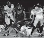  ?? PHOTOS BY MARK HUMPHREY ENTERPRISE-LEADER ?? Fighting for extra yardage. Lincoln runningbac­k, Tyler Cummings, leans over backwards and uses leg extension while going down to pick up tough yardage against West Fork. Cummings was recognized as Newcomer of the Year for small schools by NWA Media....