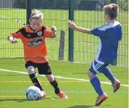  ??  ?? Action from the Age 10 match between DUSC (tangerine) and Blairgowri­e.