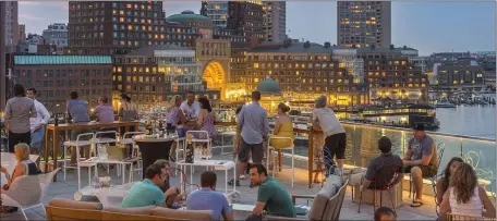  ?? HERALD FILE ?? ON THE WATERFRONT: The rooftop bar at the Envoy Hotel in the Seaport District offers great views of Boston Harbor.
