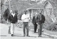  ?? Alex Brandon, The Associated Press ?? President Donald Trump, left, listens to Gov. John Bel Edwards, center, Saturday during a tour of damage from Hurricane Laura in Lake Charles, La.