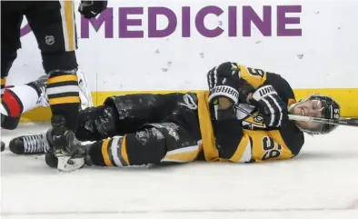  ?? Associated Press ?? Jake Guentzel crashed into the boards and fell to the ice after scoring against Ottawa Dec. 30 at PPG Paints Arena. He missed the rest of the regular season but is expected to return against Montreal.