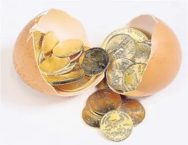  ?? FILE ?? Selection of pure gold USA treasury coins in broken egg shell illustrati­ng financial security of a retirement nest egg.