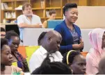  ??  ?? Ruzivo Chonyera of Harare, Zimbabwe, stands to ask a question during a networking event at FatPipe ABQ. She is among a group of about 25 young African leaders visiting Albuquerqu­e.