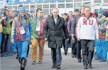  ?? AP ?? Russian President Vladimir Putin, centre, and Sports Minister Vitaly Mutko, right, during the 2014 Sochi Games.