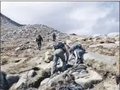  ??  ?? The volunteers are busy as hillwalker­s make their way up Goatfell.