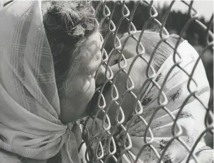  ?? POSTMEDIA NEWS FILES ?? A mother kisses her daughter through a fence separating the children and adults of the Doukhobor settlement at New Denver in July 1959.