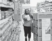  ?? DAVID J. PHILLIP/AP 2018 ?? An associate fulfills online orders at a Walmart Supercente­r in Houston.