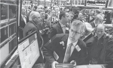  ?? RICHARD DREW, AP ?? Christophe­r Fuchs works on the New York Stock Exchange Tuesday. The S& P 500 is down 4.6% from its Aug. 2 record close.