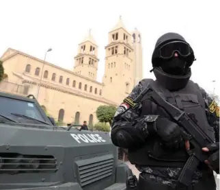  ??  ?? A security officer stands guard outside a Coptic church in Cairo. (File photo/Reuters)