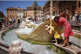  ?? Andrew Medichini / Associated Press ?? People drink from Bernini’s Barcaccia fountain, near the Spanish steps Monday, when City Hall announced that Mayor Virginia Raggi had signed an ordinance aimed at protecting some 40 fountains of historic or artistic interest.