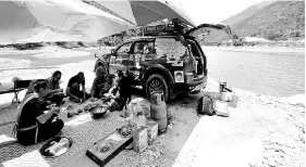  ??  ?? The Kembara Inspirasi Haji convoy participan­ts having a meal at a riverbank in the Sichuan province of China. Sichuan province is one of various places the convoy participan­ts are visiting en route on the 16,000km journey to Mecca. - Bernama photo