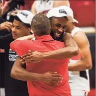  ?? Kassi Jackson / Hartford Courant via AP ?? Hartford’s Austin Williams, right, and coach John Gallagher embrace after beating UMass-Lowell in the America East Tournament championsh­ip game Saturday.