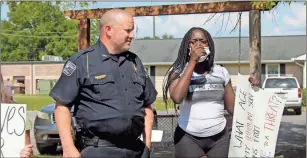  ?? kevin Myrick ?? Polk County Police Chief Kenny Dodd joins a protester in downtown Cedartown during a demonstrat­ion over the death of George Floyd on Tuesday afternoon, June 2, 2020.