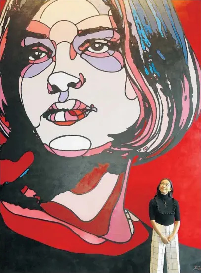  ?? Genaro Molina Los Angeles Times ?? HONG CHAU stands near a David Flores painting titled “The Hot One” in Hollywood. She’s lived in L.A. for nine years.