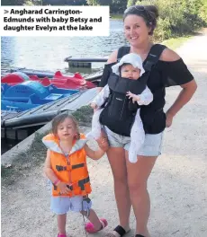  ??  ?? > Angharad Carrington­Edmunds with baby Betsy and daughter Evelyn at the lake