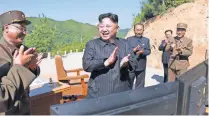  ?? KCNA VIA AFP/GETTY IMAGES ?? North Korean leader Kim Jong Un celebrates the test of an interconti­nental ballistic missile, purportedl­y on July 4.