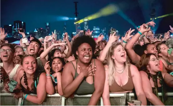  ?? ASHLEE REZIN/SUN-TIMES PHOTOS ?? Fans cheer on Post Malone, whose music spans the spectrum of rap, hip-hop, R&B, pop and rock, during his performanc­e to close Day 3 of Lollapaloo­za.