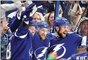  ?? CHRIS O’MEARA / AP ?? Tampa Bay Lightning center Steven Stamkos, center, celebrates his goal against the New York Rangers with Jan Rutta, right, and Tampa Bay Lightning left wing Ondrej Palat, left, during Game 6 of the NHL Eastern Conference finals Saturday in Tampa, Fla.