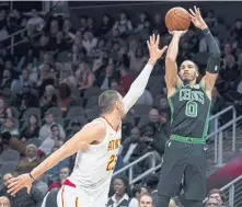  ?? ASSOCIATED PRESS ?? ZERO-ING IN: Jayson Tatum shoots over the Hawks’ Alex Len during the Celtics victory last night in Atlanta.