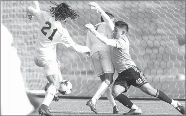  ?? NWA Democrat-Gazette/BEN GOFF • @NWABENGOFF ?? Elliott Nimrod (21) of Bentonvill­e High scores a goal as Rogers High goalkeeper Anthony Garcia (right) tries to get around Bentonvill­e’s Lucas Apparecido on Tuesday at the Tiger Athletic Complex in Bentonvill­e.