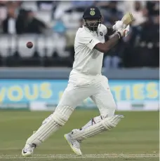  ?? AFP ?? The Indian team and coaching staff, top, including captain Virat Kohli, far right, look dejected at Lord’s. Ravichandr­an Ashwin top scored for India in both innings in the second Test