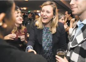  ?? Jessica Christian / The Chronicle ?? Buffy Wicks, the winner of the District 15 Assembly seat, greets supporters during her election night party at the Golden Squirrel pub in Oakland.