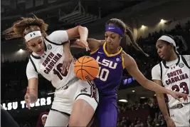  ?? CHRIS CARLSON — THE ASSOCIATED PRESS ?? South Carolina center Kamilla Cardoso vies for the ball with LSU forward Angel Reese during the first half of the Southeaste­rn Conference women's tournament final on Sunday in Greenville, S.C.