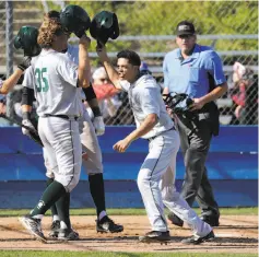  ?? Michael Macor / The Chronicle ?? De La Salle's Taison Corio (center) celebrates his two-run home run against Foothill-Pleasanton on his 17th birthday.