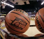  ?? DAVID J. PHILLIP - THE ASSOCIATED PRESS ?? In this April 3, 2015, file photo, basketball­s sit in a rack during Michigan State practice at the Final Four of the NCAA college basketball tournament in Indianapol­is.