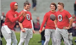  ?? ADAM CAIRNS/COLUMBUS DISPATCH ?? Ohio State quarterbac­ks, from left, C.J. Stroud, Kyle Mccord, Mason Maggs and Devin Brown, warm up prior to a game against Northweste­rn.