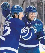  ?? NATHAN DENETTE THE CANADIAN PRESS ?? Leafs forward Trevor Moore celebrates his first NHL goal with teammate Par Lindholm in Saturday’s 5-0 win over the Vancouver Canucks. The Leafs have yet to lose three games in a row this season.
