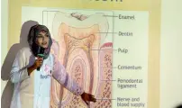  ??  ?? Dr Sadia Javed explains common oral problems such as dental caries and bad breath. The wellness camp was organised as part KT’s activities to mark Internatio­nal Women’s Day.