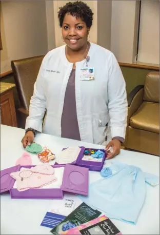  ?? WILLIAM HARVEY/RIVER VALLEY & OZARK EDITION ?? Lesly James, a licensed social worker and coordinato­r of the Conway Regional perinatal-bereavemen­t program, shows some of the items, including clothing and booklets, that she gives grieving parents. A free support group, Healing Wings, is scheduled...