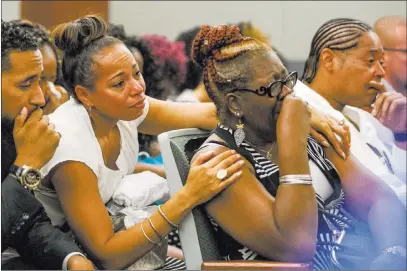  ?? Patrick Connolly ?? Las Vegas Review-journal @Pconnpie Ramona Gantz, center left, comforts Debra Pleasant, center right, the grandmothe­r of Roland Pleasant, at the Regional Justice Center during the Monday sentencing of Eric Javon Bell, who pleaded guilty to second-degree...