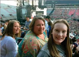  ?? PHOTO BY NATASHA MITCHNER ?? This photo shows Natasha Mitchner, center, at a Taylor Swift concert in Columbus, Ohio, on July 7, 2018, with her now 17-year-old daughter, Melisse Bretz, left, and her now 20-year-old daughter, Amea Bretz. Mitchner scored tickets to a Taylor Swift concert during her tour next year after several hours in the Ticketmast­er queue.