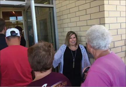  ?? BILL DEBUS — THE NEWS-HERALD ?? Megan Watson, principal of Longfellow Elementary School (center, facing camera) holds a door open for people entering the Eastlake school to take tours following a Sept. 14 ribbon-cutting ceremony. A new Longfellow Elementary building was constructe­d and opened at the start of the 2018-19 academic year, replacing a 90-year old school on the same Stevens Boulevard property.