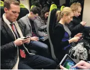  ?? JOHN KEEBLE / GETTY IMAGES ?? Mobile phones and tablets are all but ubiquitous nowadays, and bring with them an inevitable social cost.