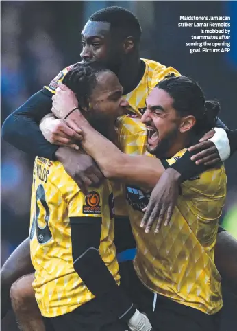  ?? ?? Maidstone's Jamaican striker Lamar Reynolds is mobbed by teammates after scoring the opening goal. Picture: AFP