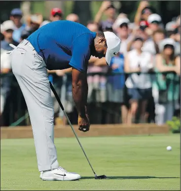  ?? — AP ?? Tiger Woods slumps after missing a birdie putt on the 11th green during the third round of the PGA Championsh­ip in St. Louis Saturday. Woods shot at 66 and is four off the lead.