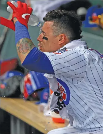  ?? JONATHAN DANIEL/GETTY IMAGES ?? Cubs shortstop Javy Baez tries to stay cool in the dugout Wednesday against the Reds at Wrigley Field. Baez went 1-for-4 with a single and a strikeout.