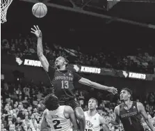  ?? Willie J. Allen Jr. / Associated Press ?? UH guard Dejon Jarreau launches a shot over Central Florida's Terrell Allen during the first half of the key AAC matchup in Orlando, Fla.