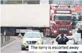  ??  ?? The lorry is escorted away