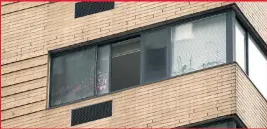  ??  ?? GRIM SITE: Michael Courtian fell to his death from this 12th-floor apartment window at 87th and Third. Cops later led his wife out in anguish.