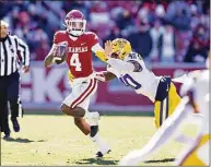 ?? Wesley Hitt / Getty Images ?? Arkansas Razorbacks’ Malik Hornsby is tackled in the second half by LSU Tiers’ Harold Perkins Jr. Saturday in Fayettevil­le, Ark. The Tigers defeated the Razorbacks 13-10.