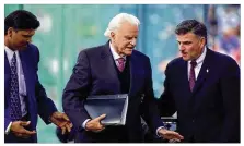  ?? DAYTON DAILY NEWS 2002 ?? The Rev. Billy Graham (center) is helped to the podium by Cincinnati Bengals great Anthony Munoz (left) and Graham’s son, the Rev. Franklin Graham, during a spiritual campaign in June 2002 at Paul Brown Stadium in Cincinnati.