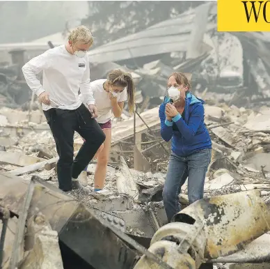  ?? JEFF CHIU / THE ASSOCIATED PRESS ?? Mary Caughey, right, finds her wedding ring Tuesday after her home was destroyed by fires in Kenwood, Calif.