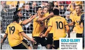  ??  ?? GOLD GLORY Wolves celebrate Willy Boly’s goal against Man City
