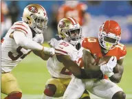  ?? Chris O'Meara / Associated Press ?? The 49ers’ Jimmie Ward, center, tackles Chiefs receiver Tyreek Hill during the second half of Kansas City’s 31-20 victory in Super Bowl LIV on Sunday in Miami Gardens, Fla.